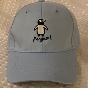 Light blue Penguin embroidered cap with snap back adjustable closing, by Miniso.